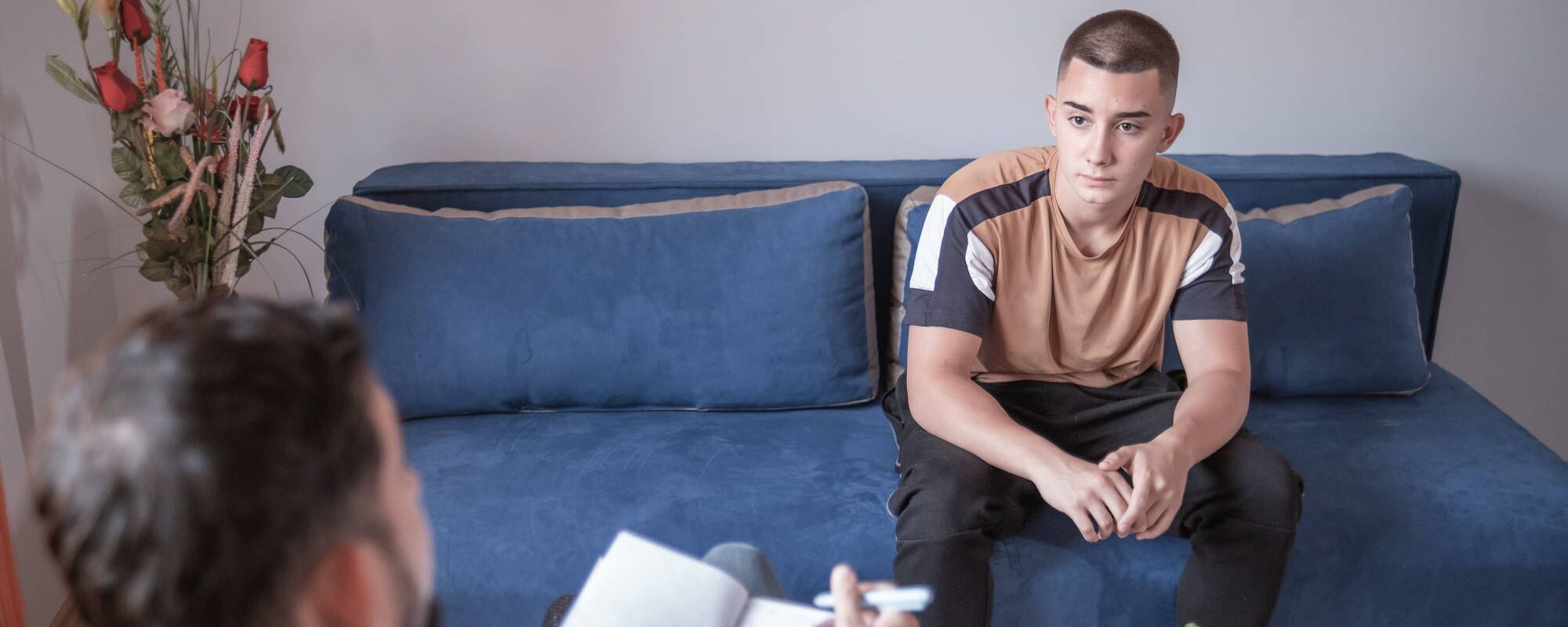 A young man in an individual therapy session for teen OCD treatment at Pillars Health Group in Concord, MA.