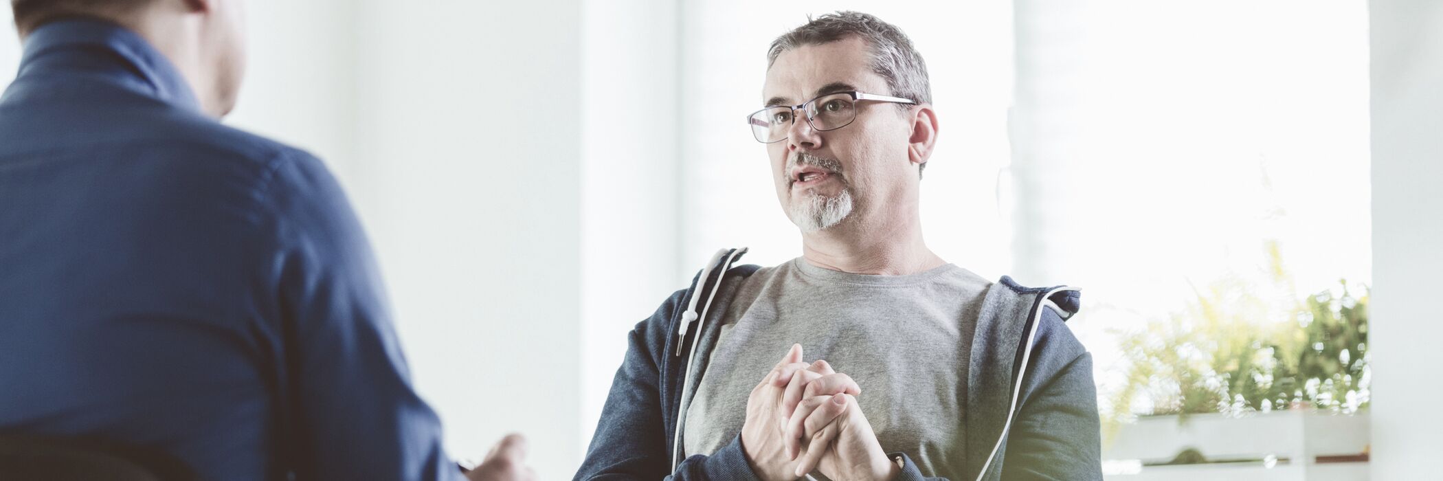 A man in an individual therapy session for outpatient PTSD treatment at Pillars Health Group.