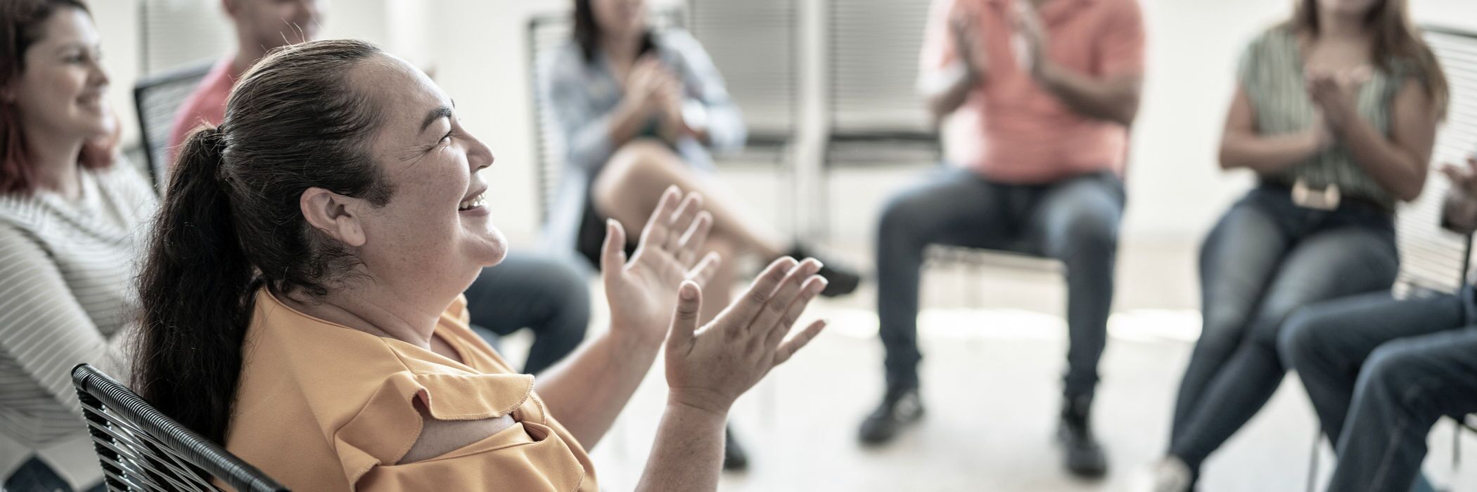 A woman in a group therapy session for the Alumni Program at Pillars Health Group.